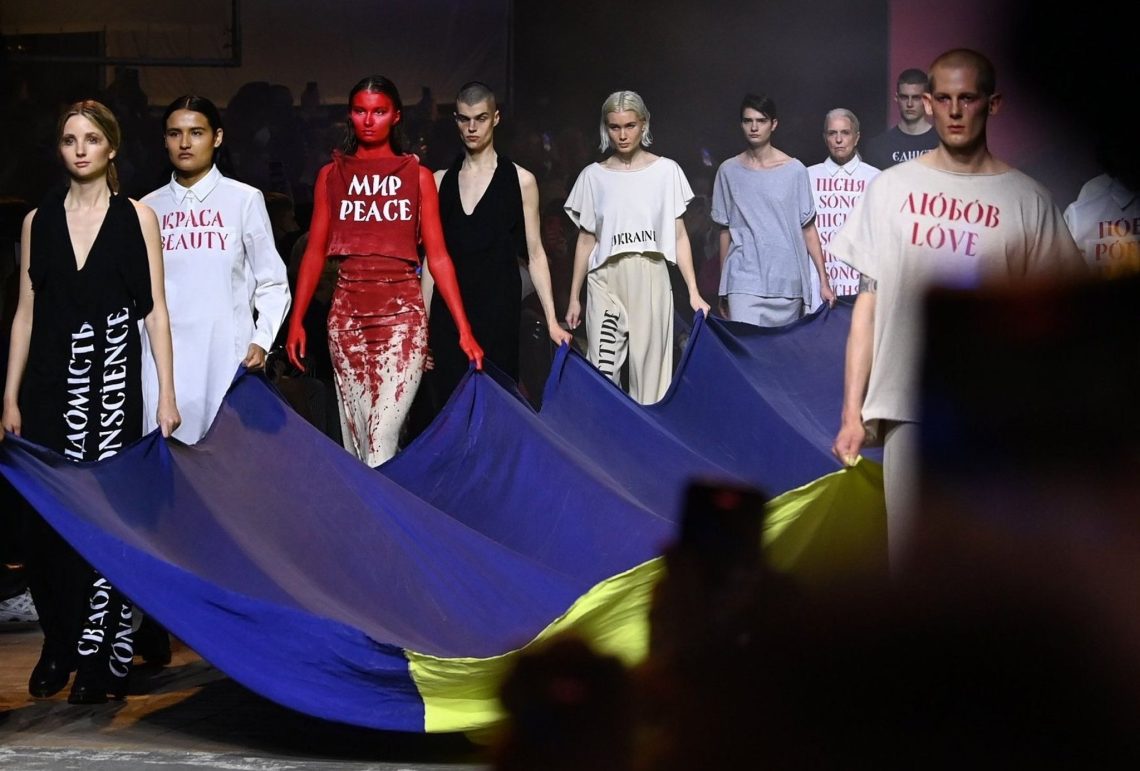 Berliner Modewoche: Im Kraftwerk Berlin präsentieren Models Kreationen des ukrainischen Designers Jean Gritsfeldt und tragen dazu eine ukrainische Fahne.